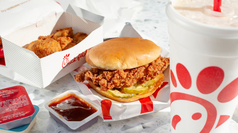 Chick-fil-A sandwich, nuggets, and drink on a table