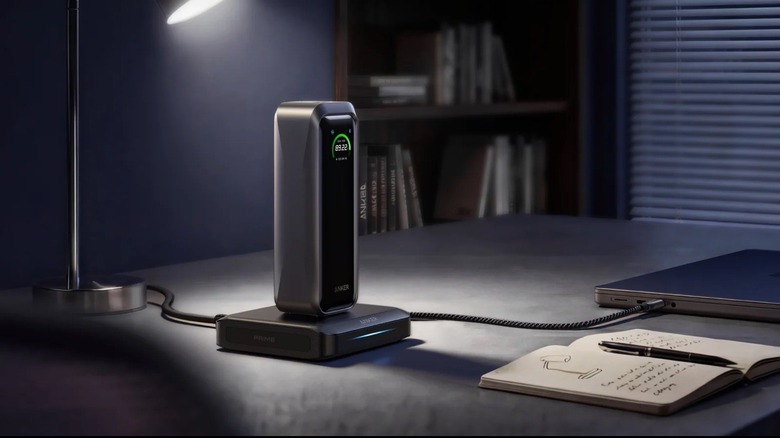 Anker's portable power bank being charged on a table and also charging a MacBook