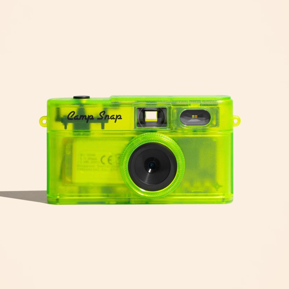 A compact plastic camera with transparent casing featuring a single lens and viewfinder