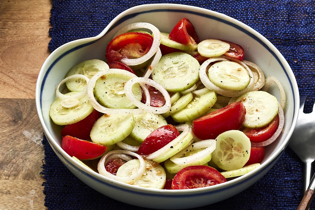 a low angle view of a bowl of Marinated Cucumber Onion Tomato Salad