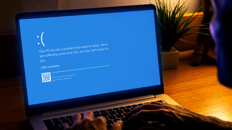 Laptop displaying the Windows "Blue Screen of Death" (BSOD) after a system crash.