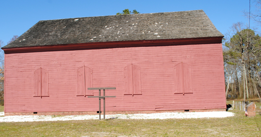red exterior of the old christ church in laurel delaware