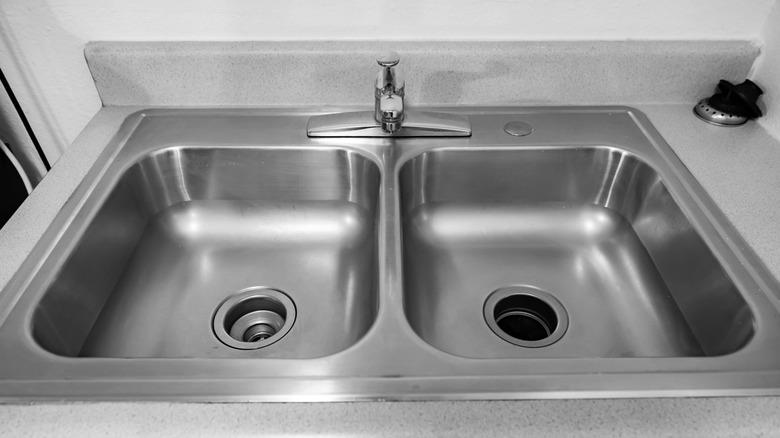 The Unexpected Reason You Should Leave Paper & A Glass In Your Sink While You're Away