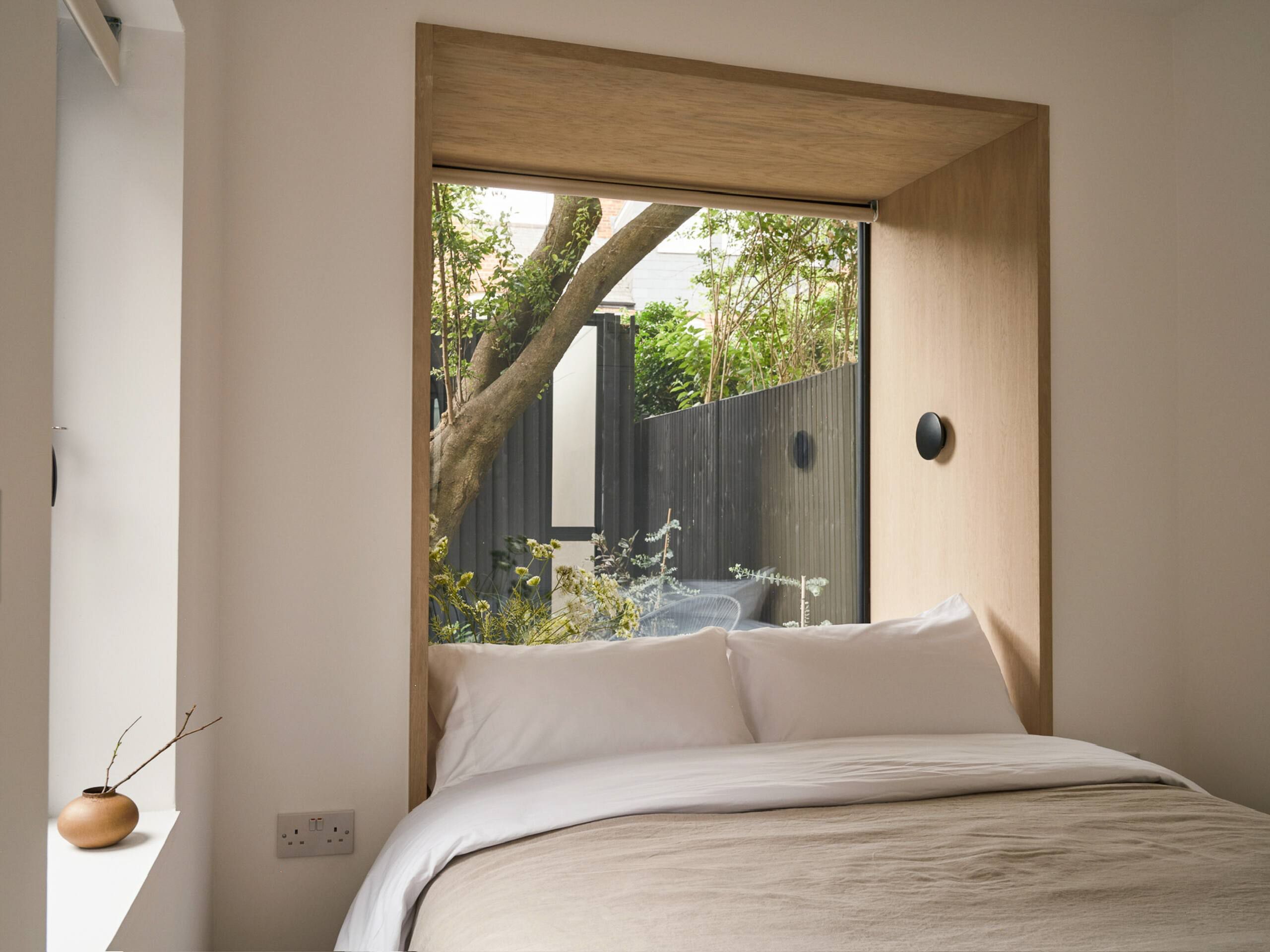A second bedroom with windows looking out through the courtyard