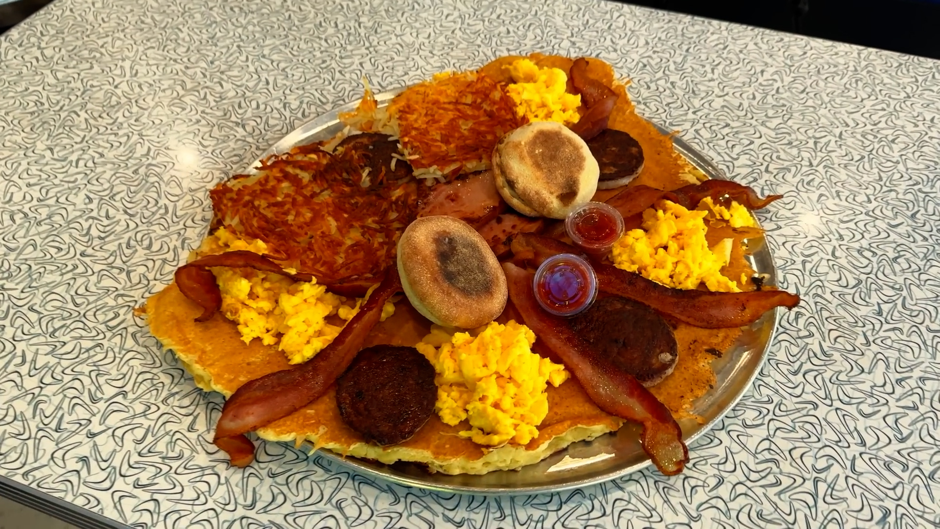 Man attempts giant pancake breakfast challenge served on a 16-inch platter