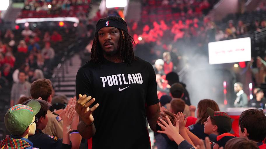 Portland Trail Blazers center Robert Williams III greets fans as he walks toward the court