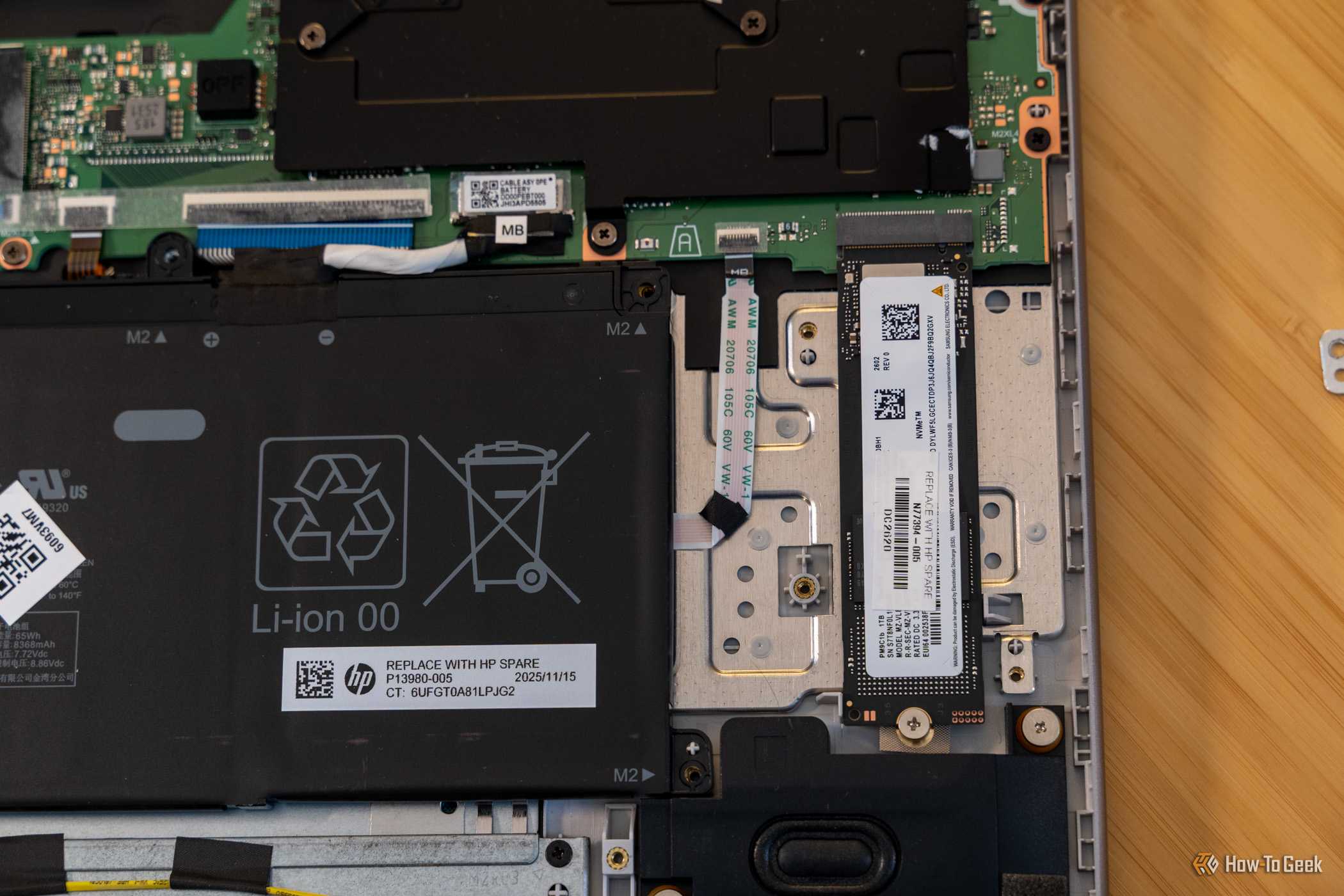 HP OmniBook 3 internal NVMe SSD and replaceable battery close-up.