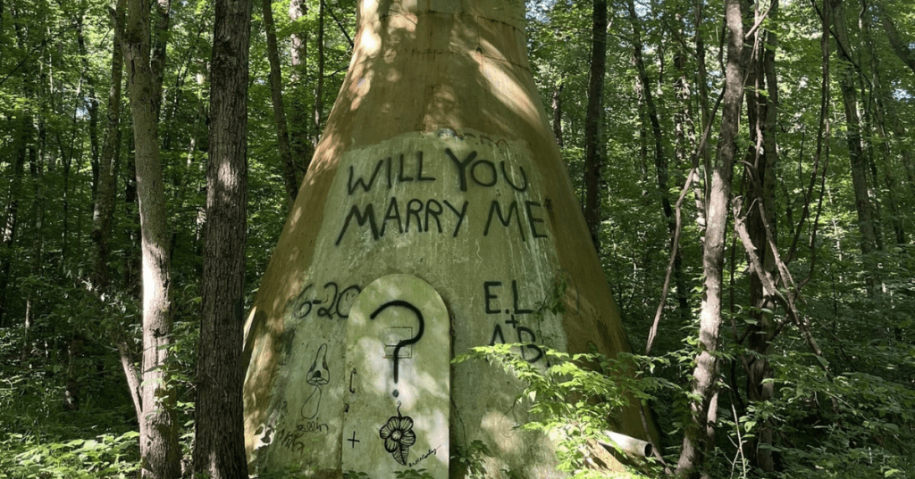 Graffiti proposal on a concrete structure along a wooded trail at Stonelick State Park in Ohio.