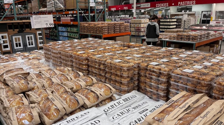 Costco bakery section with garlic bread, baguettes, and muffins