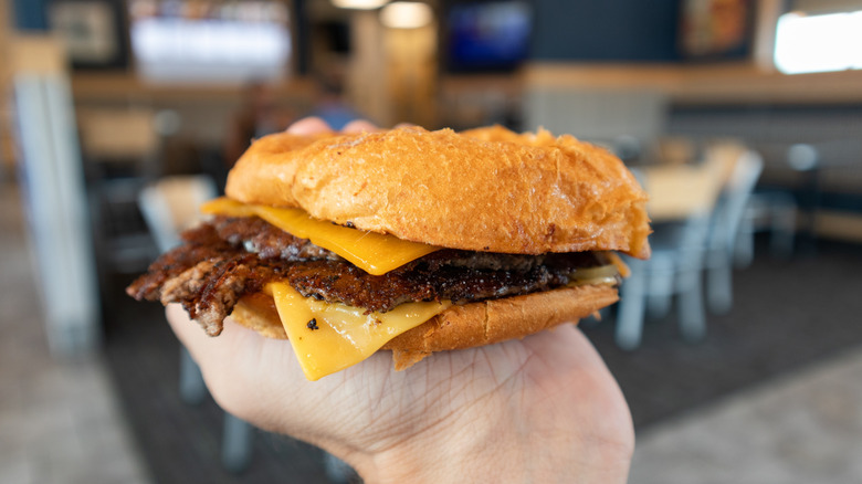 A hand holds a Culver's ButterBurger