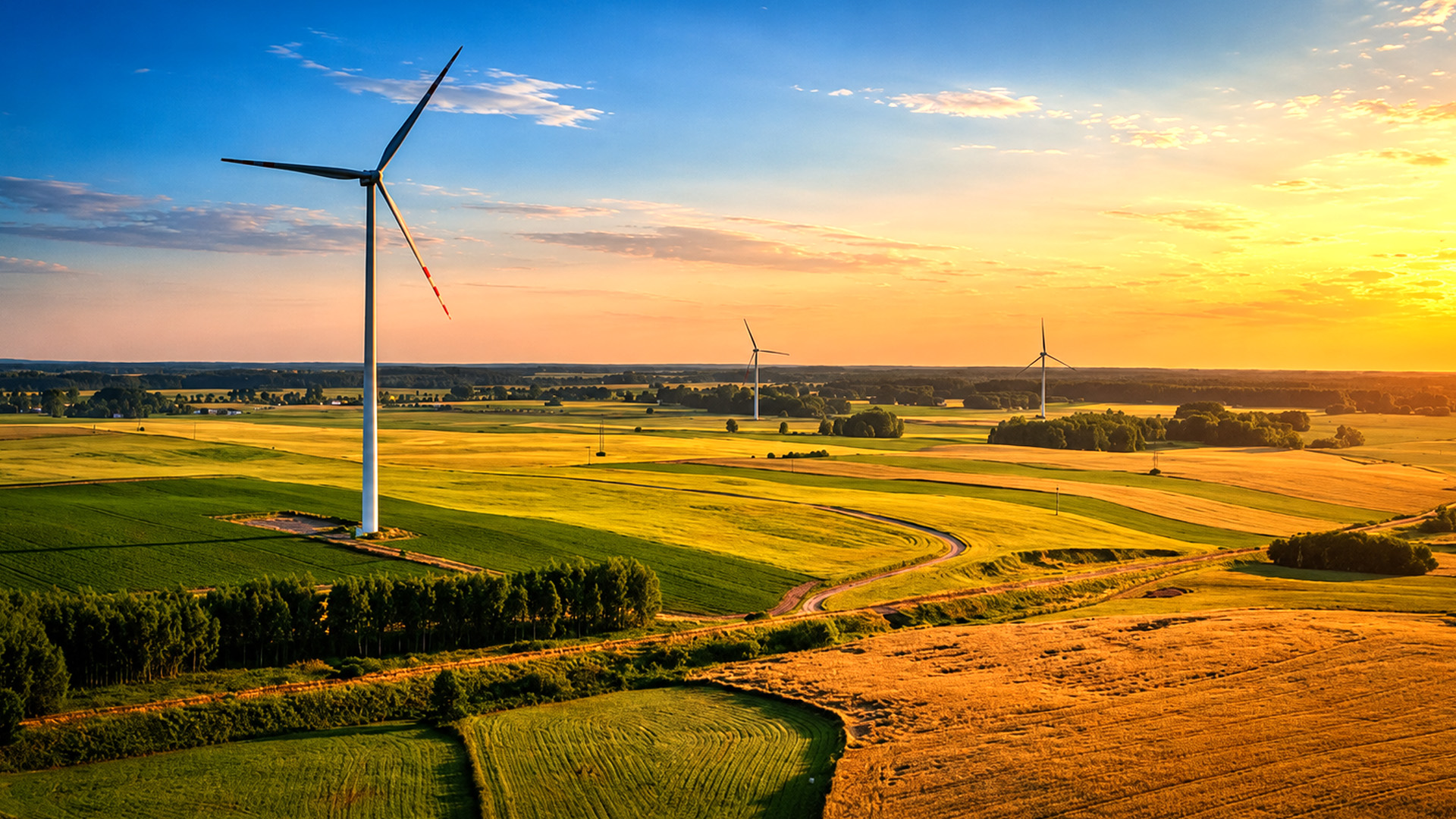 Wind turbines standing beside Jurassic limestone cliffs and green fields