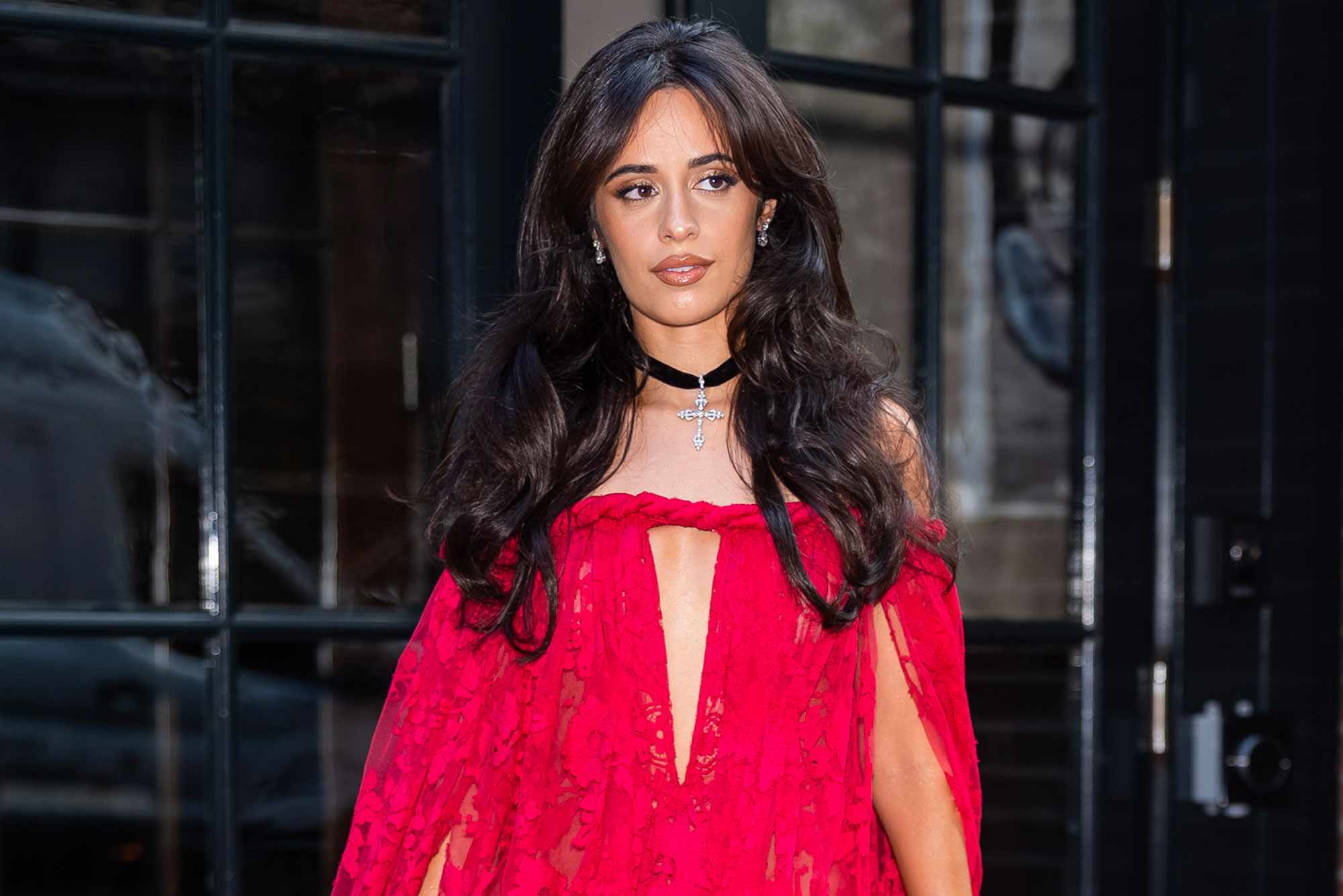 Camilla Cabello steps out in a fuchsia lace gown as she heads to Taylor Swift and Travis Kelce's NYC wedding