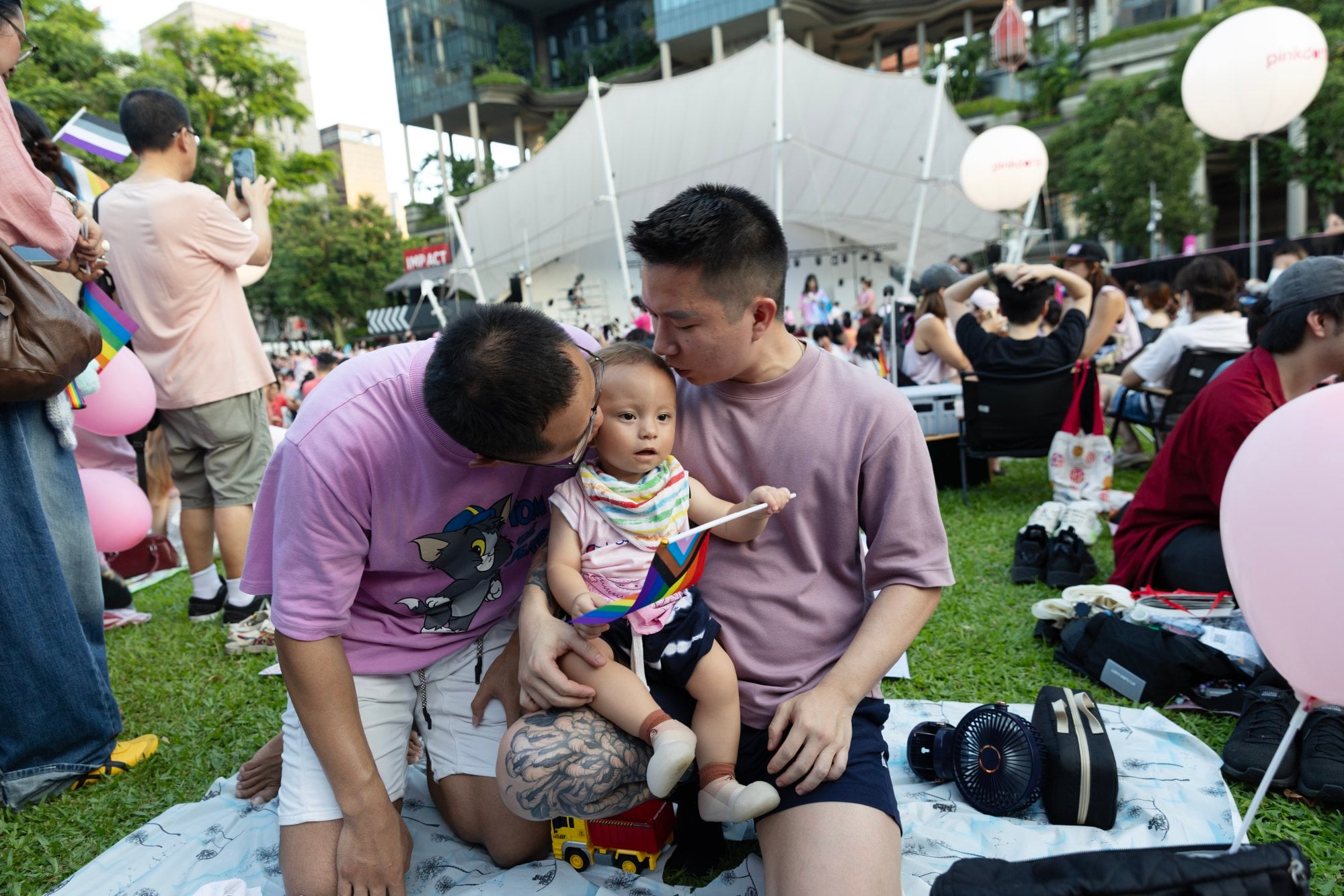 Same-sex parents kiss their son during the Pink Dot SG pride event in Singapore on June 27. Photo: EPA