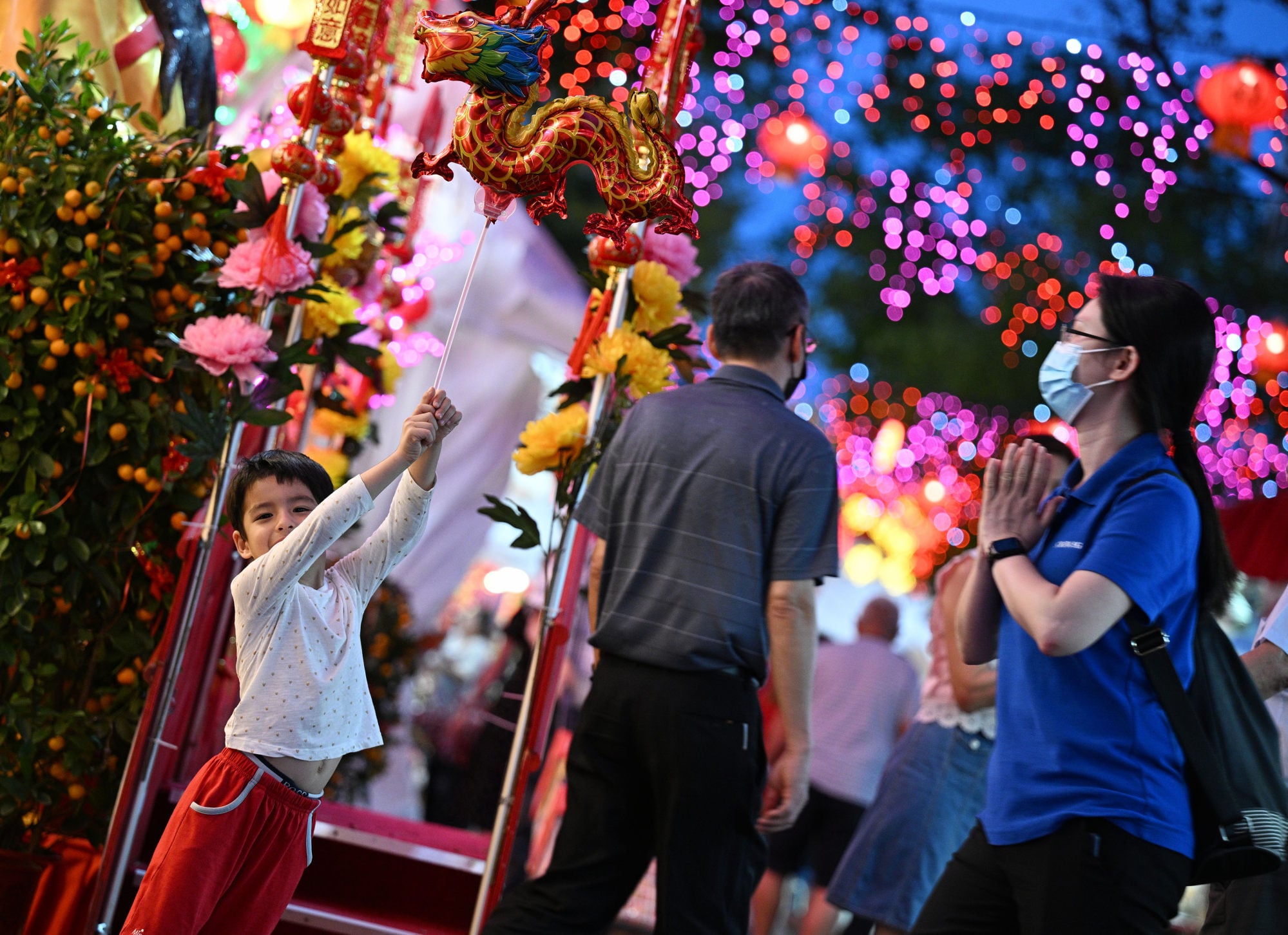 A child poses for photos at a Chinese New Year market in Singapore in 2024. Photo: Xinhua