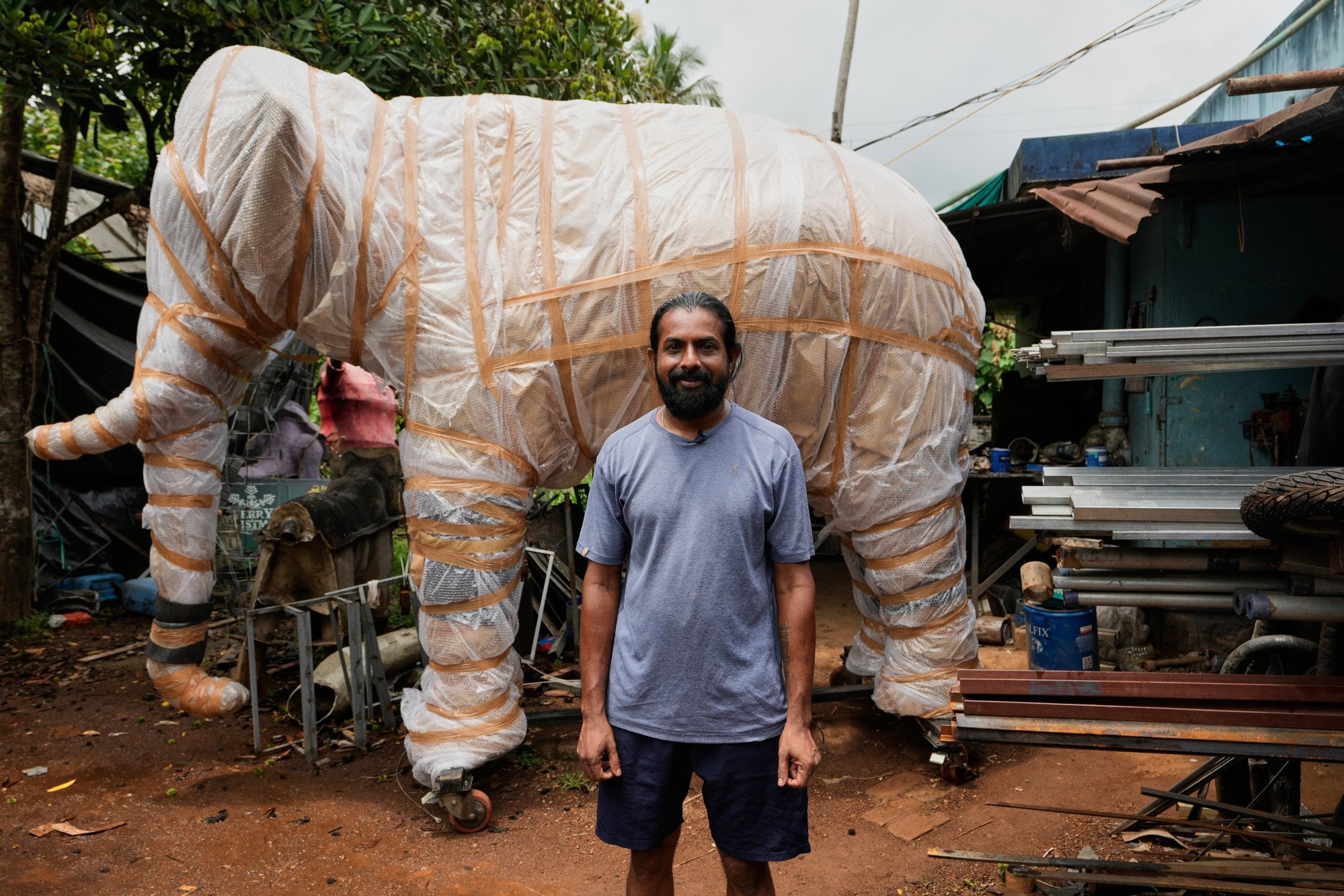 Prasanth Prakashan, a mechanical engineer, poses in front of a robotic elephant at his backyard workshop in Chalakudy, in the southern Indian state of Kerala, in May. Photo: AP