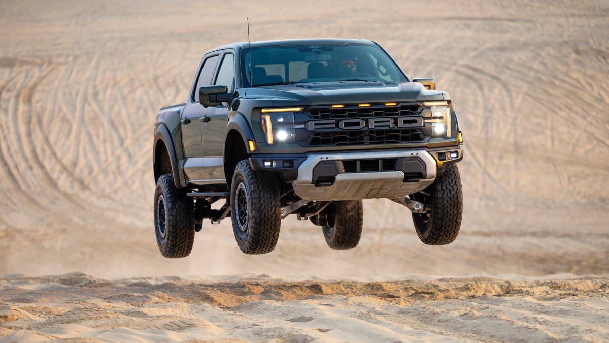 2025-2026-ford-f-150-raptor-in-agate-black-dune-jumping
