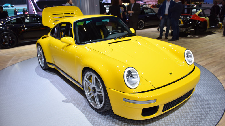 A reimagined RUF Yellowbird Porsche parked on display.