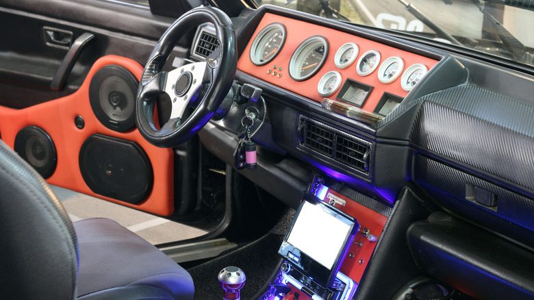 A 1980s in-car view of aftermarket screens and audio.