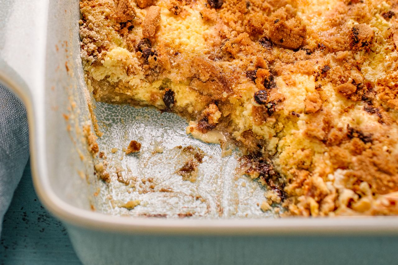 Freshly baked chocolate cookie dump cake in a baking dish with part of it scooped out