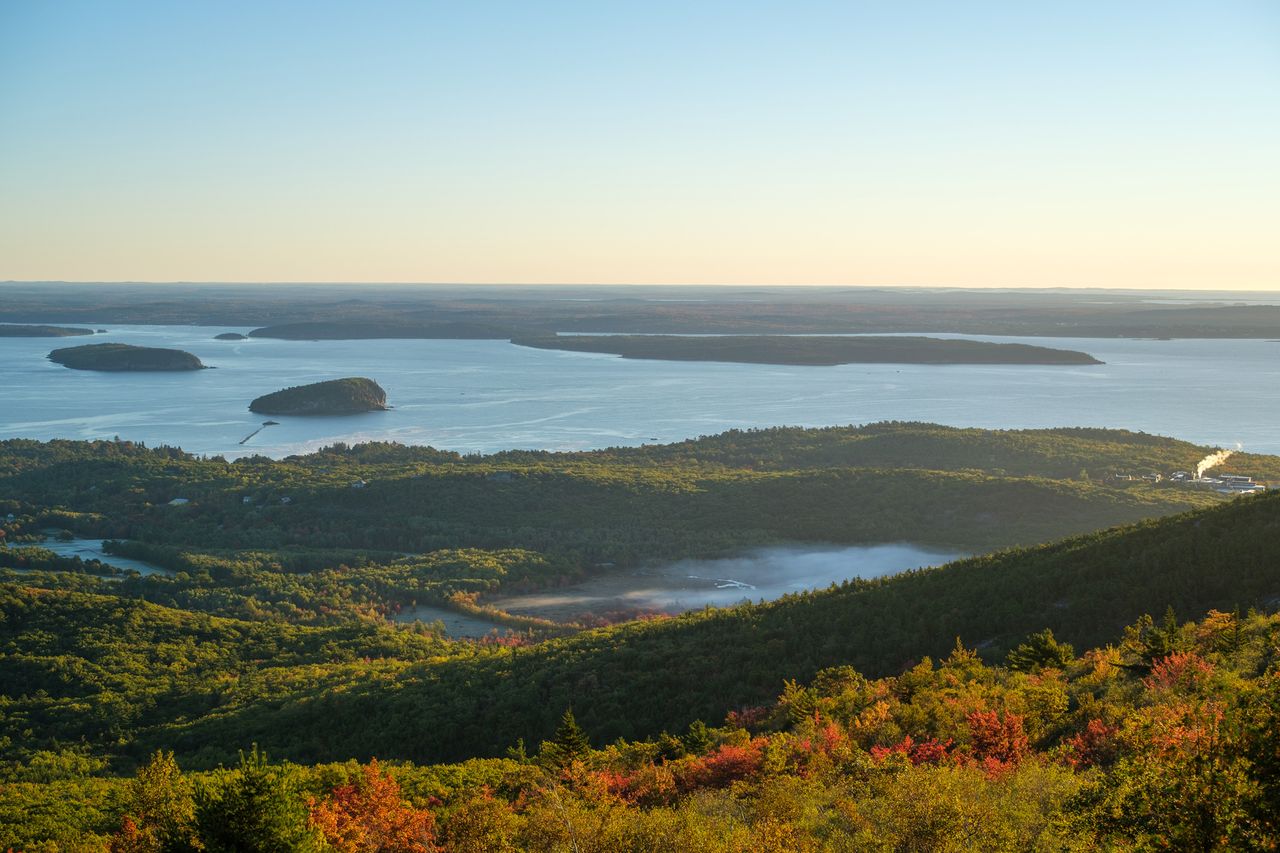 Frenchman Bay with islands and forested hills in the foreground viewed from a high vantage point