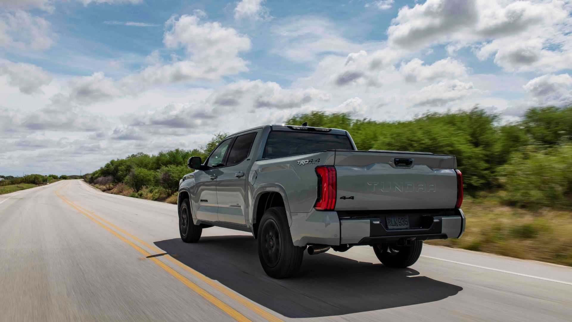 A rear three-quarter shot of a 2022-2025 Toyota Tundra i-Force Max driving