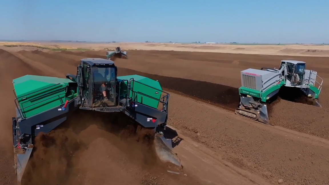 Heavy compost machinery transforming organic waste into valuable compost