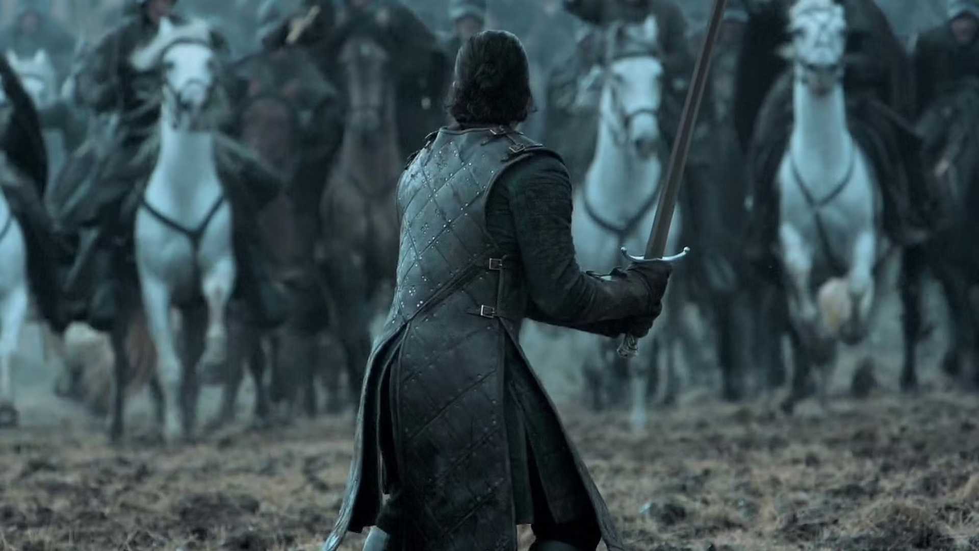 Jon Snow holds up a sword in Game of Thrones