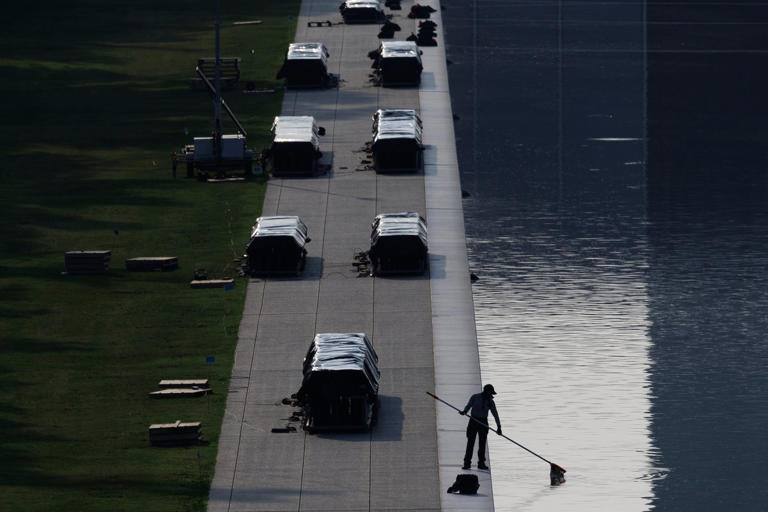 A worker clears debris from the Lincoln Memorial Reflecting Pool, Wednesday, July 1, 2026, in Washington. (AP Photo/Tom Brenner)