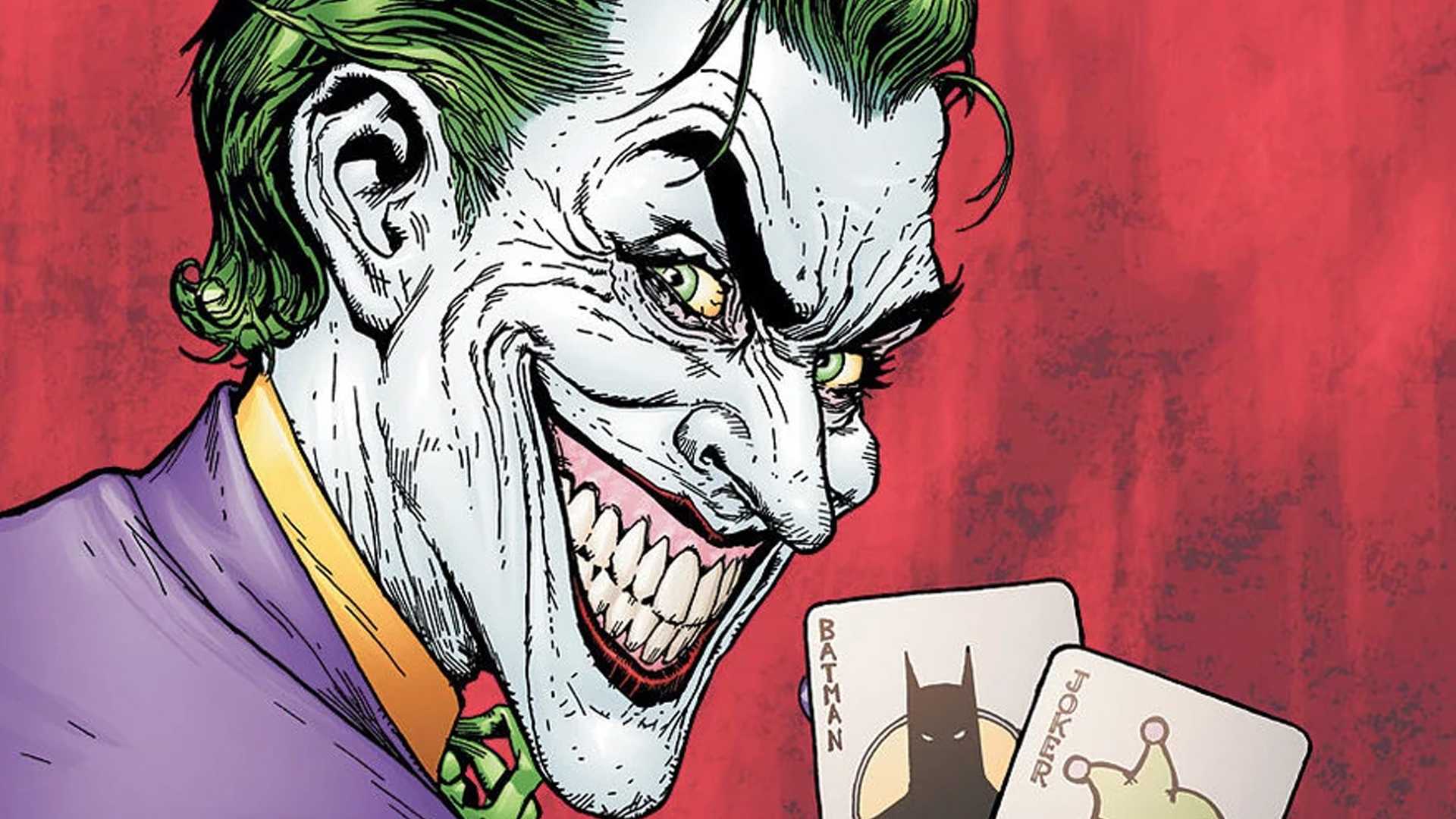The man who laughs Jojer smiling while holding cards