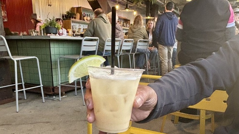 A man enjoys a drink at the Royal Bar at the Rock Island Bridge complex, Kansas City, Kansas