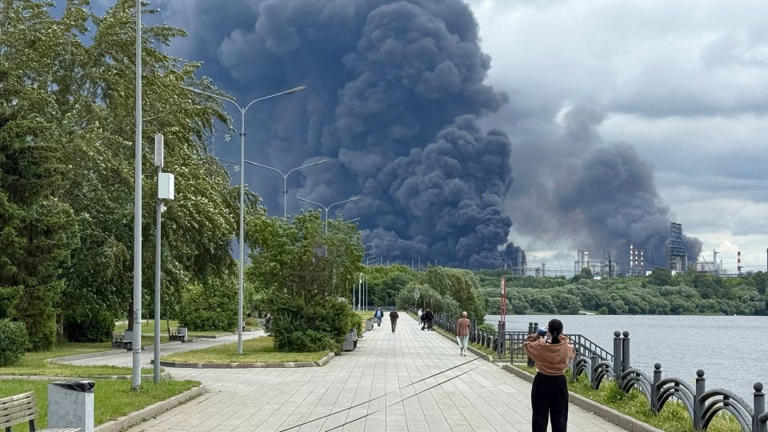 Smoke rises over Russian oil producer Gazprom Neft's oil refinery near Moscow on June 18. Russian and Ukrainian forces have increased attacks on each other's energy infrastructure. - AFP/Getty Images