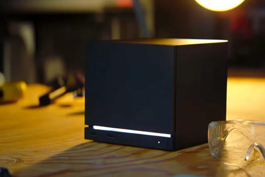 Valve's Steam Machine under warm lighting.