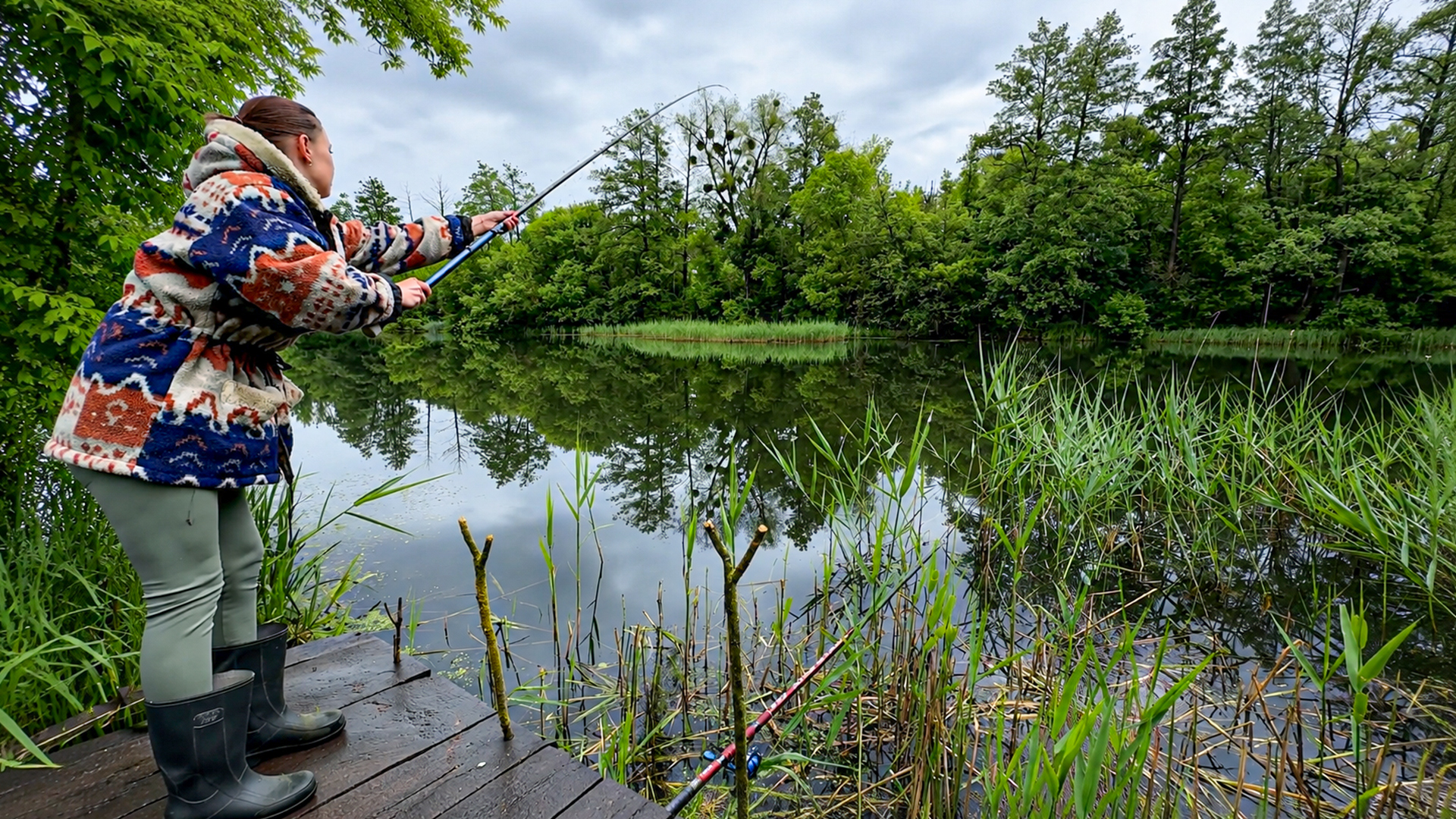 Fishing by the village lake on a peaceful rural day