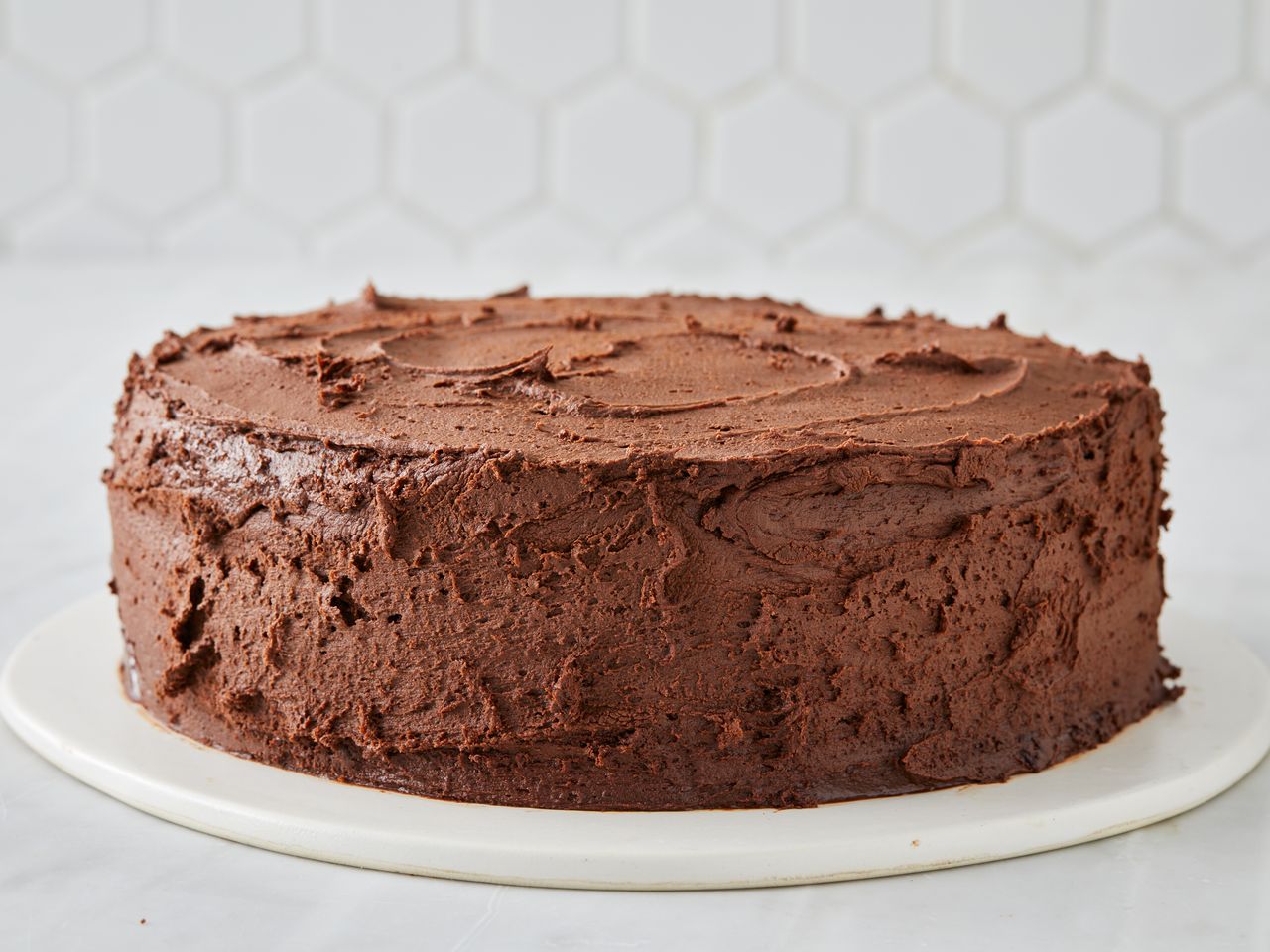 close up view of Back-of-the-Box Hershey's Chocolate Cake with chocolate icing on a white platter