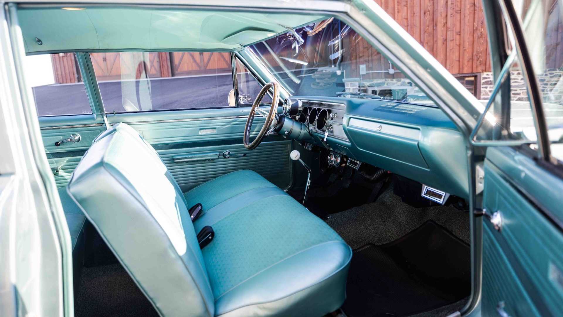 The front bench seat of an entry-level classic Chevrolet sedan.