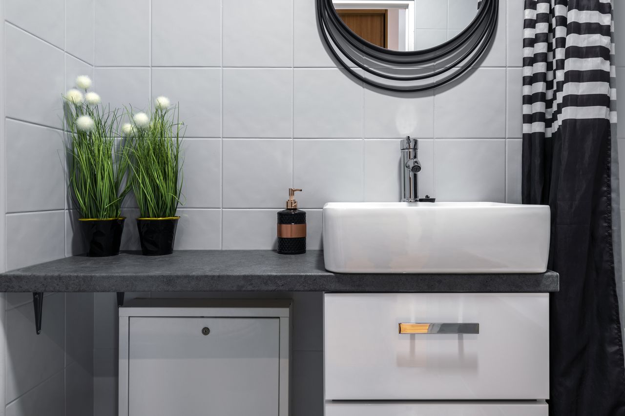 Vessel sink in gray and black bathroom