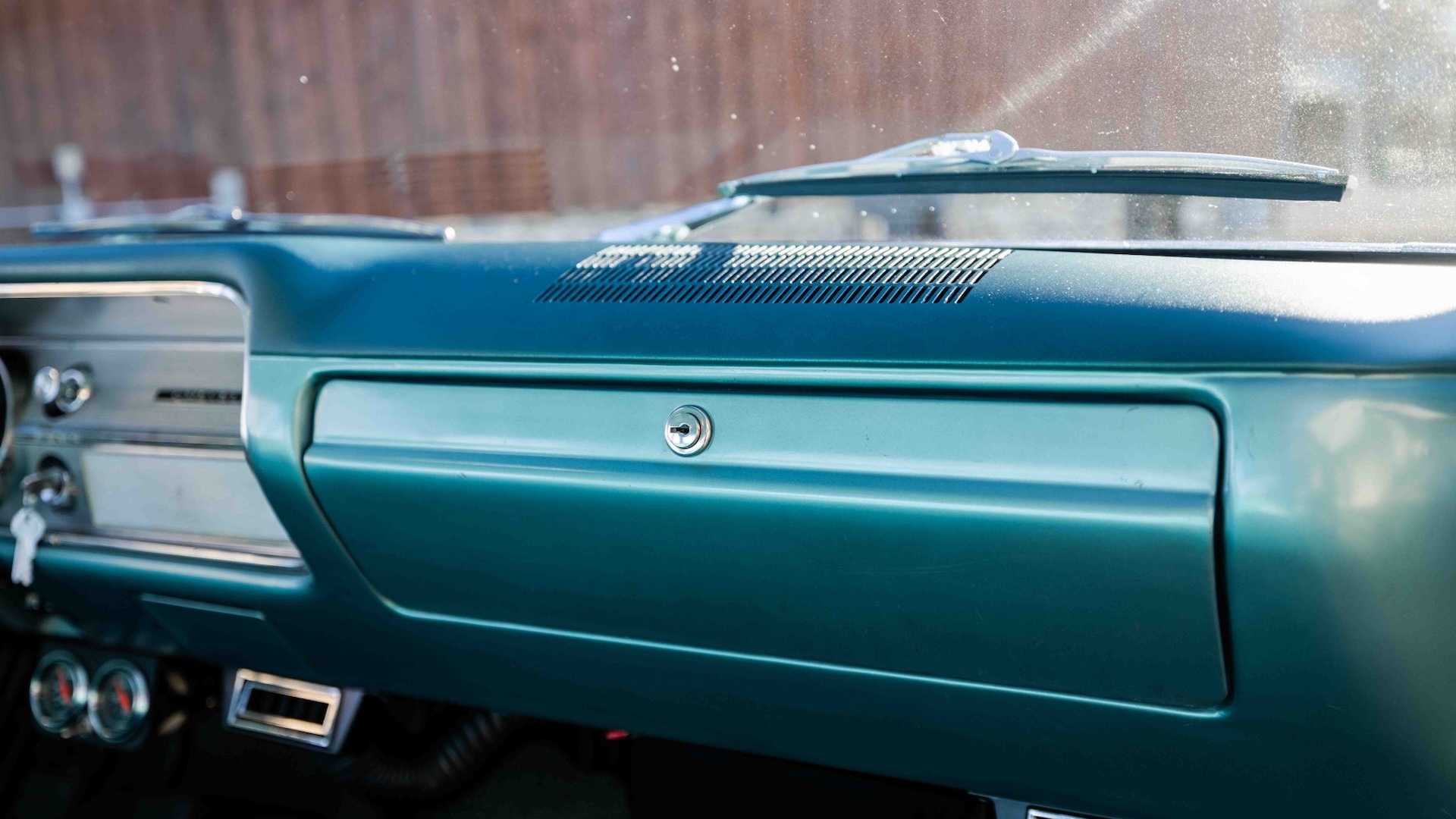 The turquoise painted dashboard in a classic Chevrolet car