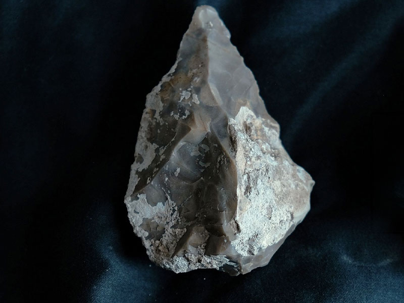 Prehistoric handaxe discovered in the ancient cave. © Emil Aladjem, Israel Antiquities Authority