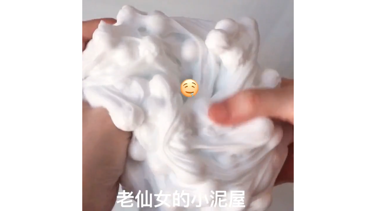 Poking and stretching white bubble slime creating soft cloud pop texture