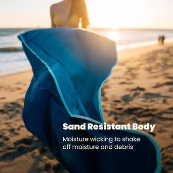 Person on a beach holding a sand-resistant towel, with text promoting its moisture-wicking feature to reduce sand and debris