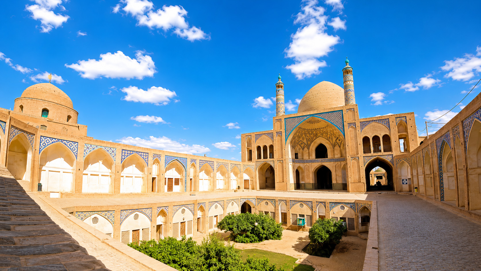 Agha Bozorg Mosque’s twin minarets above a sunken courtyard