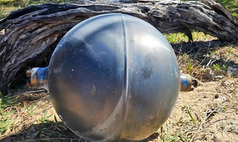 Mysterious metallic spheres from space force closure of Australian beach