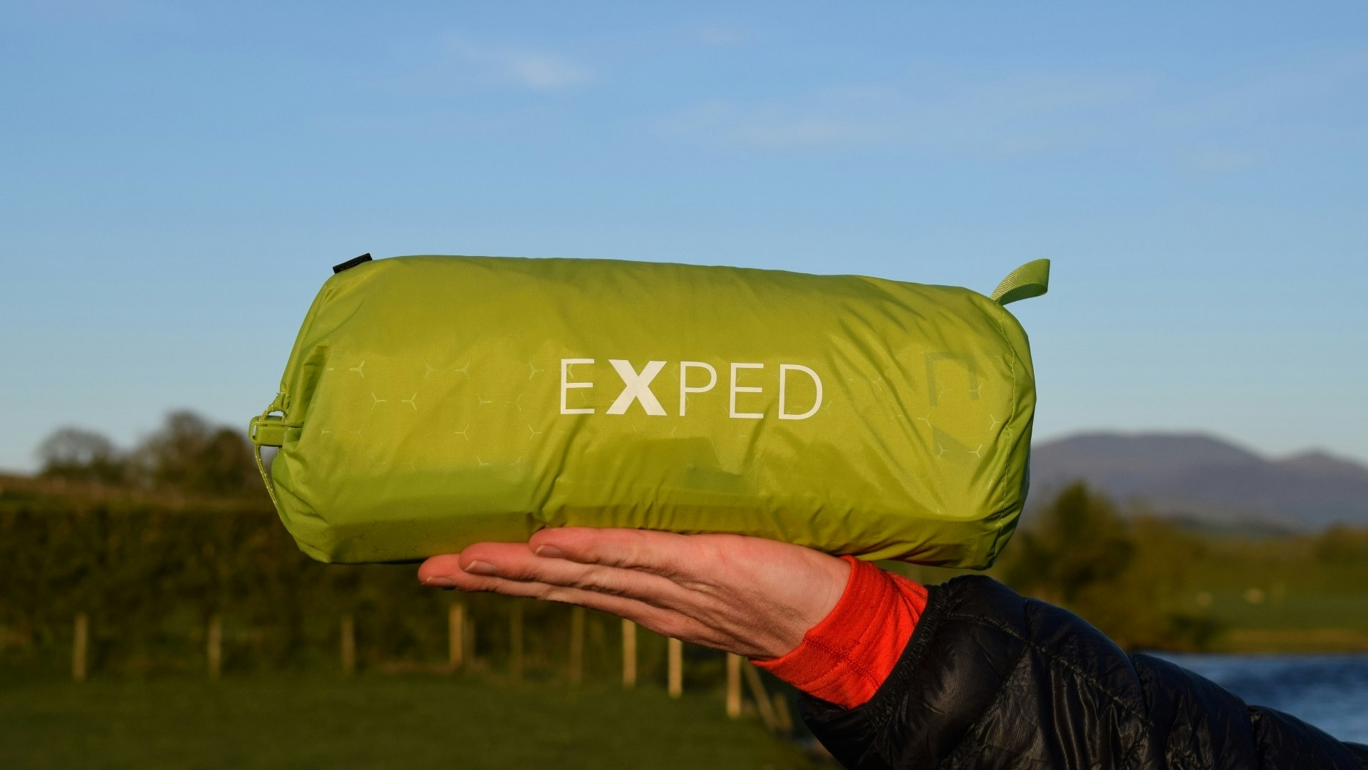 James holding the packed Exped Ultra 6.5R sleeping mat horizontally