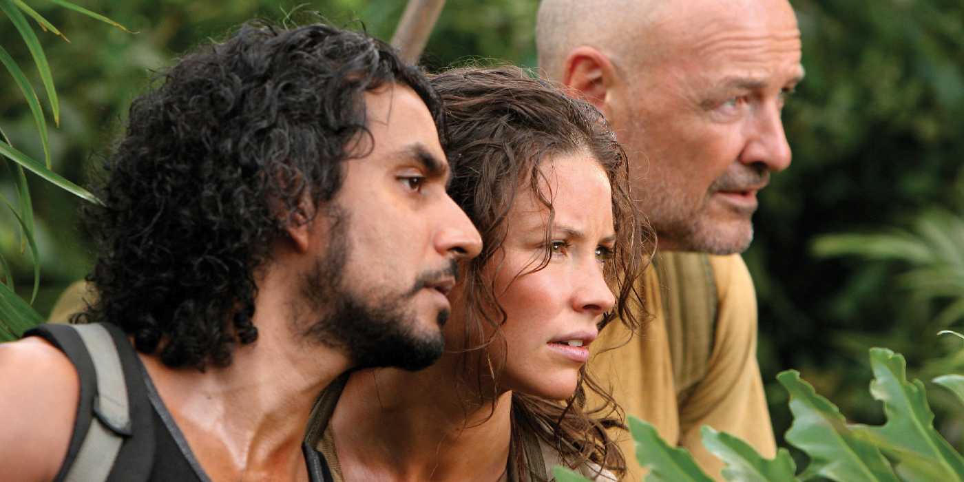 Sayid Jarrah, Kate Austen, and John Locke stand in the bushes, watching someone in Lost Season 3, Ep. 13