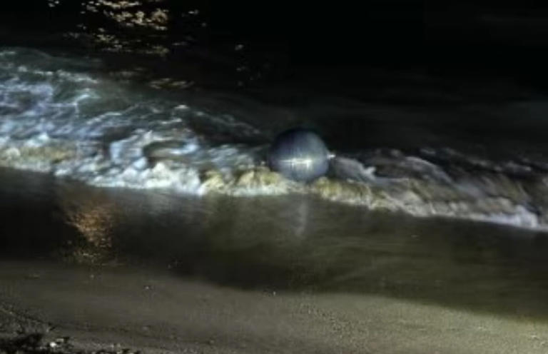 Mysterious metallic spheres from space force closure of Australian beach