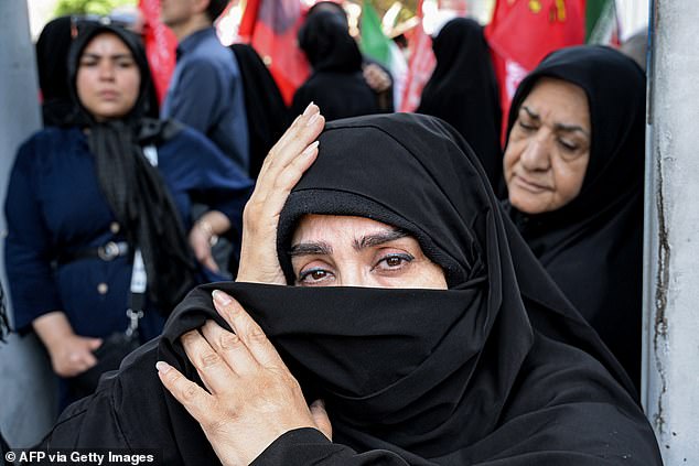 A woman mourner reacts during a funerary procession for Iran's slain supreme leader Ali Khamenei and his family members near Azadi Square in Tehran on July 6, 2026