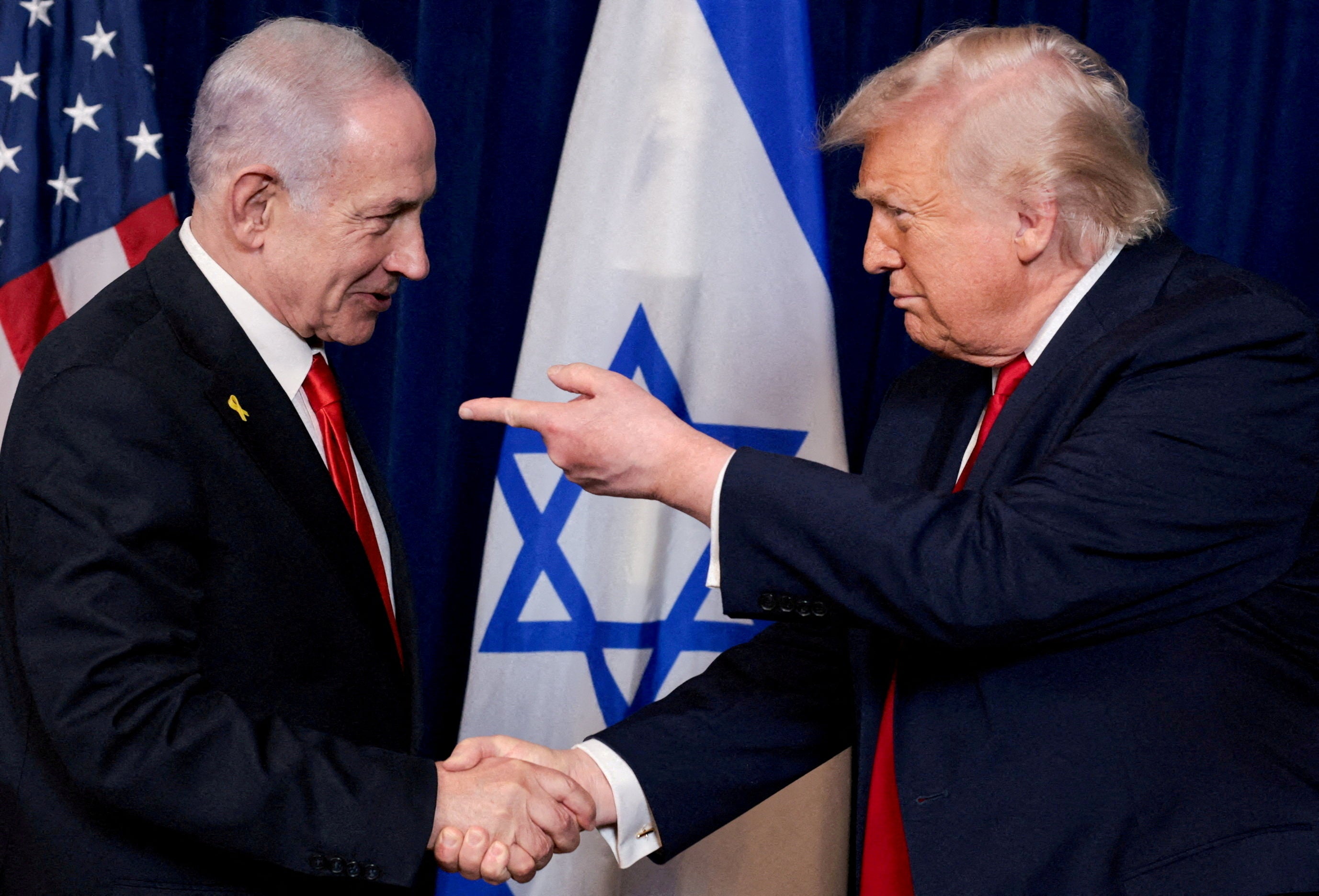 President Donald Trump points his finger towards Israeli Prime Minister Benjamin Netanyahu as they shake hands during a press conference after meeting at Trump’s Mar-a-Lago club in December 2025 (Reuters)