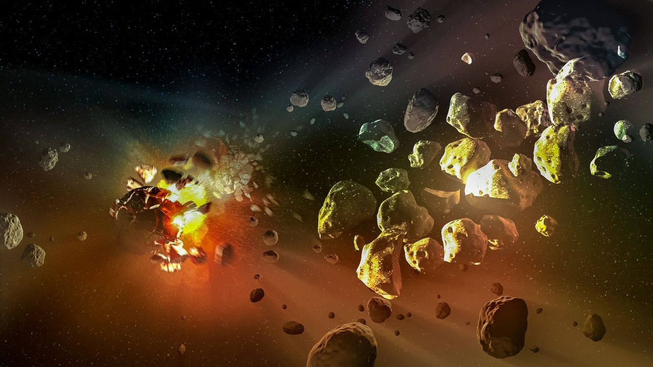 an explosion in space sends a rocky asteroid breaking apart into smaller chunks of rock