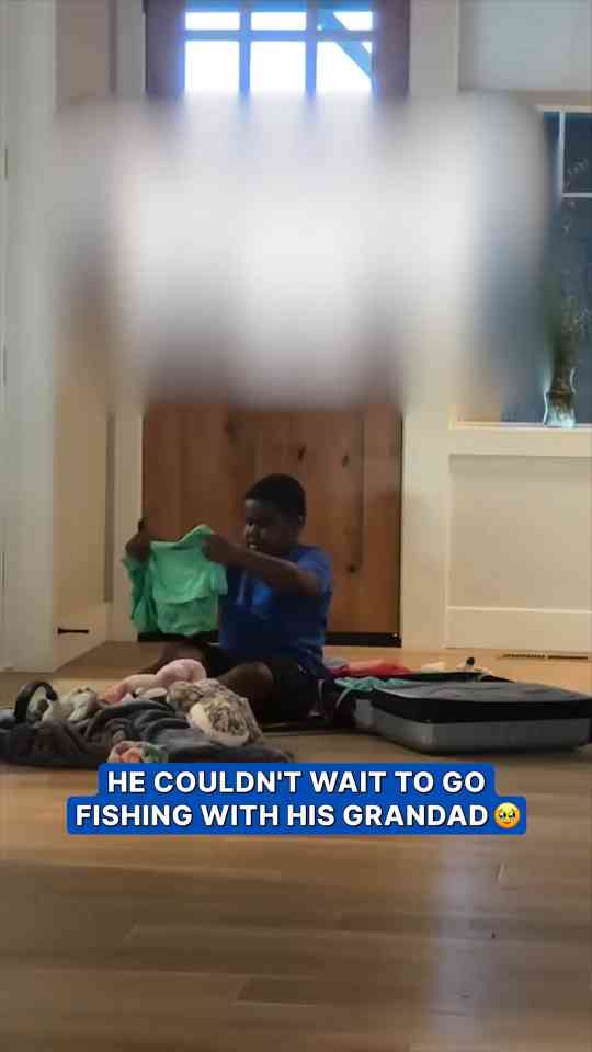 Young boy eagerly prepares for fishing trip with grandfather
