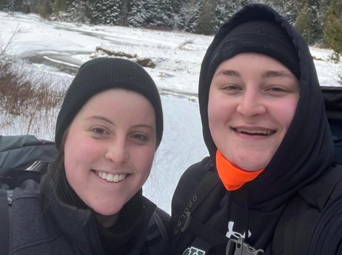 Shea and Maria taking a selfie in the snow, both smiling